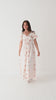 Video of a woman wearing a floral dress on a white background